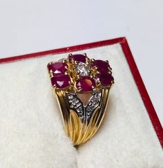 Gorgeous Vintage 14k Yellow Gold Diamond and Natural Ruby Ring: Diamonds: 0.25CT Color: G-I Clarity: SI1-SI2 Ruby: 1.80 CT Total ring weight: 5.8 GR 14K Yellow Gold Ring sizing available free of charge For more information regarding this item feel free to reach me so I can accommodate your needs. Thank you Formal Ruby Ring With Diamond Accents In Cluster Shape, Formal Cluster Ruby Ring With Diamond Accents, Cluster Yellow Gold Hallmarked Rings, Yellow Gold Cluster Rings Hallmarked, Yellow Gold Cluster Ring With Hallmark, 14k Gold Ruby Ring For Formal Occasions, Gold Cluster Ruby Ring Hallmarked, Gold Cluster Ruby Ring, Hallmarked, Classic Ruby Ring With Diamond Accents In Cluster Shape