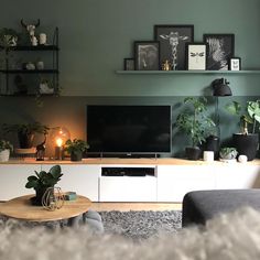 a flat screen tv sitting on top of a white entertainment center