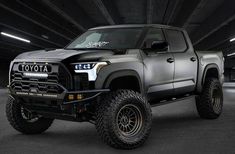 a black toyota truck parked in a parking garage