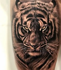 a tiger tattoo on the leg of a man