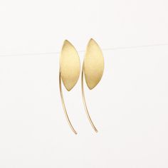 Unique minimalist solid 14k gold earrings. These marquise drop earrings are handcrafted of yellow 14k solid gold. They have a brushed finish with smooth shiny edges. They are lightweight and comfortable. These geometric earrings will add a chic touch of gold to your appearance. They are perfect for everyday wear and will add a refined and stylish look when combined with elegant night wear. A great gift for someone you love, or a treat for yourself. Silicone cups are included for safety. Earring' Contemporary Teardrop Yellow Gold Earrings, Contemporary Yellow Gold Teardrop Earrings, Modern Gold Threader Earrings As Gift, Elegant Recycled Gold Earrings With Ear Wire, Modern Recycled Gold Earrings As Gift, Modern Recycled Gold Earrings For Gift, Minimalist Yellow Gold Dangle Earrings, Modern 14k Gold Threader Earrings, Modern 14k Gold Filled Linear Earrings Gift