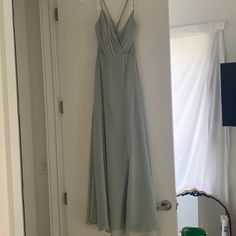 a dress hanging on the wall in front of a mirror