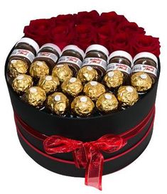 a heart shaped box filled with chocolates and roses