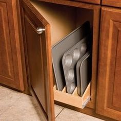 an open cabinet with dishes and utensils in it