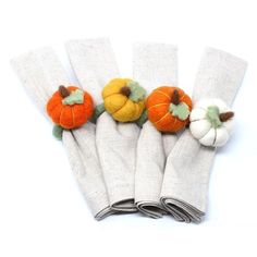 five small pumpkins sitting on top of white napkins