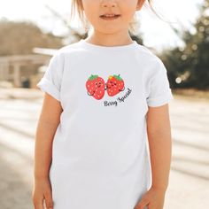 "Our \"Berry Special\" strawberry toddler + kids tee features a cute front chest print. This yummy design will be your new favorite shirt that you reach for again and again! Want a matching mama tee? We got you, just check out our shop!  * Q U I C K * F A C T S * ♥ Solid colors made from 100% ringspun cotton, Heather colors made from 100% ringspun cotton + polyester ♥ Design is high quality digital print ♥ Wash and dry normally (on cool for best results) * S I Z I N G * ♥ True to size ♥ Please see size guide in listing photos for all measurements and information * S H I P P I N G * T I M E S * ♥ Our items are custom made to order with love  ♥ We're working as quickly as possible and know speed is important! Our processing time is UP TO 7 business days but typically 2-5 business days, plus Cute Funny Print T-shirt, Cute Pink Shirt With Strawberry Print, Cute Crew Neck Shirt With Strawberry Print, Cute Strawberry Print Shirt, Cute Strawberry Print Crew Neck Shirt, Playful White Tops With Strawberry Print, Cute Pink T-shirt With Fruit Print, Cute Short Sleeve T-shirt With Strawberry Print, Relaxed Fit White T-shirt With Strawberry Print