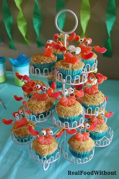 cupcakes are arranged in the shape of crabs on top of a cake stand