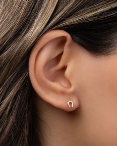 Tiny 14k gold horseshoe stud earring. Part of our Tiny Stud collection, this is sold as a single and great for mixing and matching or purchase two for a dainty pair. Available in 14k yellow, white and rose gold. Sold as a Single Size: Approx. 4mm (H) by 5mm (H) Standard Production: 2-7 business days Rush Order Production: 1- 4 business days Shipping: Select shipping method at checkout. Shipped from our L.A. Studio. This item is Final Sale. See here for details. Elegant Horseshoe Earrings For Gift, Tiny Studs, Stud Earring, Yellow White, Rush, Gold Color, Jewelry Box, Yellow Gold, Stud Earrings