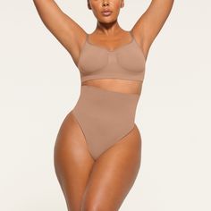 Get ultimate compression with our highest support level in this high-rise shapewear thong that sculpts, smooths, and tones your core and tummy. Wear this silky staple under everything to enhance your natural shape. Features removable adjustable straps. | SKIMS High-Waisted Thong | Medium Neutral | Core Control Shapewear Thong, Thong Shapewear, Cute Lingerie, Tummy Tucks, Natural Shapes, Shapewear, Classic Black, Adjustable Straps, Lounge Wear