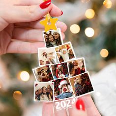 a woman holding up a christmas tree ornament with photos on it and a star hanging from the top