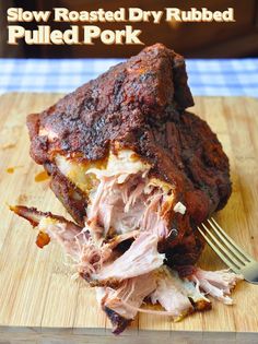 slow roasted dry rubbed pulled pork on a cutting board with a fork and knife