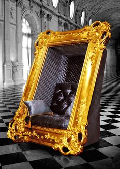 an ornate gold frame sitting on top of a black and white checkerboard floor