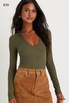 The Lulus Obviously Perfect Olive Green Ribbed V-Neck Bodysuit is an absolute must-have for every babe's closet! Stay comfy and cute in this stretchy ribbed knit bodysuit that features a flattering V-neckline framed by long fitted sleeves. The figure-hugging bodice continues down to attached thong bottoms with snap closures, perfect for tucking into your favorite high-waisted denim! Fit: This garment fits true to size. Length: Size medium measures 30" from shoulder to hem. Bust: Great for any cup size. Waist: Fitted - stretchy fabric allows custom fit. Hip: Fitted - stretchy fabric allows room for hips. Undergarments: May be worn with any standard bra. Fabric: Fabric is very stretchy. Lined. 96% Polyester, 4% Spandex. Hand Wash Cold. Do Not Bleach. Line Dry. Iron Low Heat. Imported. Lulus Chic Solid Color V-neck Bodysuit, Spring V-neck Elastane Bodysuit, Solid V-neck Bodysuit For Work, V-neck Bodysuit For Workwear, Trendy Elastane Bodysuit For Fall, Trendy Fall Bodysuit In Elastane, Trendy Stretch V-neck Bodysuit, Stretch Solid Color V-neck Bodysuit, Trendy Stretch Bodysuit With V-neck