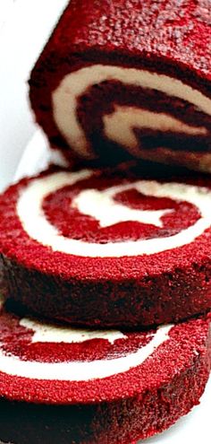 red velvet cake roll with white swirls on top