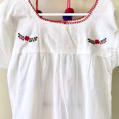 This traditional Mexican blouse is beautifully made in Merida Yucatan, Mexico, each piece is individually hand made and hand embroidered. You will love this lightweight blouse made of organic cotton, this natural material gives the blouse a delicate and relaxed feel. Details: Size M-L measurements: Bust: 42” - 29” length(shoulder to bottom Hem) Cotton thread Embroidered Material: 100% Cotton All items are shipped from the US All Mi Mundo Mexicano items are 100% handmade by artisans in Mexico. Ea Cotton Peasant Top With Embroidered Hem, Multicolor Embroidered Cotton Peasant Top, White Folk Style Embroidered Top With Resham Embroidery, White Cotton Festival Peasant Top, White Folk Style Top With Resham Embroidery, White Cotton Peasant Top For Festival, Traditional Cotton Peasant Top With Embroidered Hem, Cotton Folk Peasant Top With Embroidered Border, Bohemian Cotton Top With Chikankari Embroidery