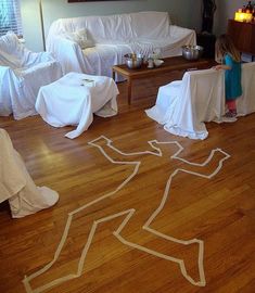 a child standing in front of a living room with white furniture and decorations on the floor