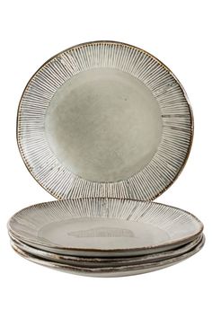 four silver plates stacked on top of each other