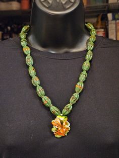 These delicious, Kelly green and orange, melon shaped beads are a modern interpretation of traditional, Luxurious Venetian-style glass trade beads. I collected them decades ago from the artisan, while I was on a trip to Indonesia. The pendant is a murrini glass flower produced when I was in a hot glass workshop in Singapore with internationally famous glass artist B. Jane Cowie. I prong-set the flower in a hand-made sterling silver mount so it can be worn separately as a brooch, or suspended fro Trade Beads, Kelly Green, Green Orange, Bead Necklace, Chain Styles, Green And Orange, Long Necklace, Prong Setting, Singapore