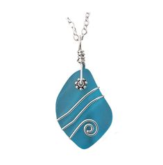 a blue pendant with silver wire on a white background