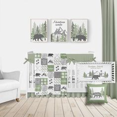 a baby crib with three pictures on the wall and two bears in the forest