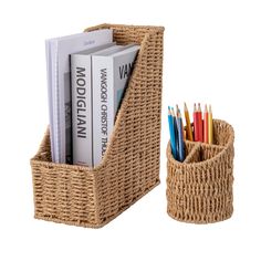 a basket with books and pencils in it next to a cup filled with pens