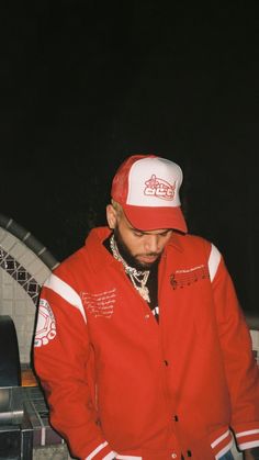 a man wearing a red jacket and white hat