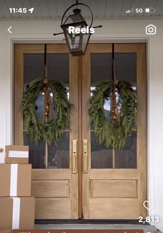 the front door is decorated with wreaths and boxes