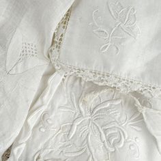 white linens with embroidered designs on them