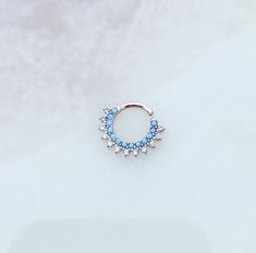 a small blue and white ring sitting on top of a table