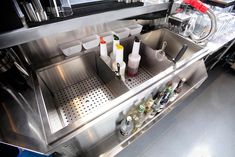 a stainless steel counter top with bottles on it