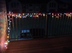 a car is parked on the deck with christmas lights