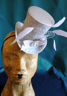 This simple and elegant bridal mini top hat is covered with a combination of light grey satin along with damask brocade in the same tones. It is embellished with grey veil around the crown, light lilac feathers, grey ribbon and a sparkling round rhinestone buckle. This mini top hat is fully lined with satin and attaches to the head with thin elastic that goes under the hair, to ensure stability and achieve that perfect angled look. Measurements : approx.4.5 inches (11 cm) tall , 6.5 inches (16.5 Mini Top Hats, Bridal Mini, Grey Ribbon, Mini Top Hat, Spring Wedding Flowers, Wedding Fascinators, Cocktail Hat, Top Hats, Kentucky Derby Hat