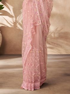 Designed to perfection, this stunning peach saree is adorned with intricate thread work, sequin work, and zarkan work, adding a touch of glamour and elegance to your look. The saree comes with a matching color net blouse featuring the same detailed embellishments, creating a cohesive and sophisticated ensemble.
The 5.50-meter saree and unstitched blouse material allow for customization according to your size and style preferences, ensuring a perfect fit and a personalized touch. Whether you're a Traditional Peach Pre-draped Saree With Dupatta, Peach Saree With Dori Work, Traditional Peach Saree For Reception, Diwali Peach Saree With Zari Work, Festive Peach Pre-draped Saree With Pallu, Designer Pink Net Dupatta, Anarkali Peach Saree With Zari Work, Unstitched Peach Saree With Resham Embroidery, Peach Anarkali Saree With Zari Work