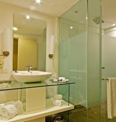 a bathroom with a glass shower stall and sink