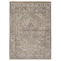 a rug with an intricate design on the front and back side, in grey tones