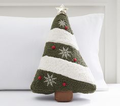 a knitted christmas tree sitting on top of a pillow