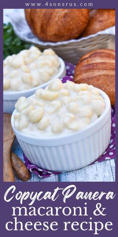 two bowls filled with macaroni and cheese next to croissants on a table