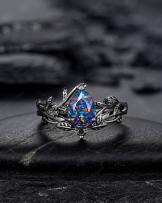 Rhodium black engagement ring like no other. This AMAZING piece of fine jewelry is the perfect expression of your eternal love. Its BLACK colors bring out the beauty of this ring. Black gold finish pear cut black opal leaf engagement ring set, rhodium black teardrop black opal twig branch bridal set, gothic vine anniversary ring, witchy black plating black opal promise ring gift for women, mom, best friend, girlfriend and wife. ★Description Main ring: *Center stone: 6x8mm Pear Cut Lab Created Bl Black Sapphire Ring With Accent Stones For Wedding, Black Birthstone Rings For Anniversary, Black Promise Ring With Accent Stones, Black Promise Rings With Accent Stones, Black Fine Jewelry For Proposal, Black Birthstone Rings For Gifts, Black Wedding Jewelry With Birthstone, Black Birthstone Jewelry For Wedding, Black Sapphire Promise Ring