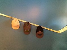 three baseball caps and a measuring tape on a blue surface with two hats hanging from it's sides