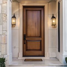 a wooden door with two lights on each side and an entry way leading into the house