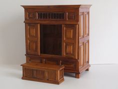 an old wooden cabinet and bench are on display