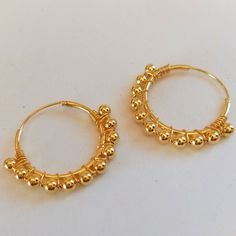 Pair of 2 cm diameter Hoop Earrings made in Sterling Silver with gold plating. These earrings are decorated with 3mm diameter beads set along the hoop. They are very elegant and original earrings that favor your face by providing light and harmony. They are made of 925 Sterling silver and have an 18 carat Gold plating that gives it a very elegant finish. The type of closure is Congo. The indicated price is for the PAIR of Earrings (right ear and left ear) Metal Hoop Beaded Earrings For Pierced Ears, Metal Hoop Beaded Earrings, Adjustable Pierced Hoop Earrings, Adjustable Hoop Earrings With Ear Wire, Gold Wire Wrapped Hoop Earrings, Adjustable Round Wrap Earrings, Everyday Small Hoop Beaded Earrings, Gold Hoop Beaded Earrings For Pierced Ears, Gold Small Hoop Beaded Earrings With Ear Wire