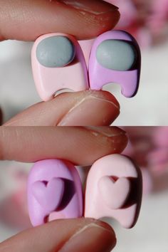 a person is holding some pink and blue nail polishes in their hand with hearts on them