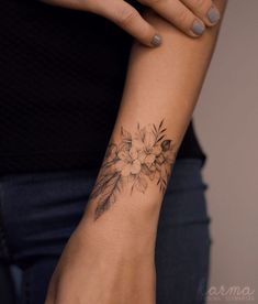 a woman with a flower tattoo on her arm