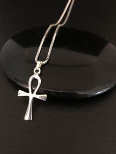 Dainty Ankh Necklace, Sterling Silver Ankh Pendant, Egyptian NecklaceNECKLACE FEATURES:Metal:  All components are made from solid .925 Sterling Silver Model is wearing 16" in length solid .925 Sterling Silver Chain Length available:  16", 18" or 20"MEASUREMENT:  Sterling Silver Ankh PendantHeight: 28mm (1.1 inches)Your Sterling Silver Ankh Necklace will arrive in a gift box, beautifully wrapped and ready for giftingPlease send me a message if you have any questions before or after placing your o Luxury Ankh Necklace For Gift, Handmade Metal Ankh Necklace, Gothic Ankh Necklace In Metal, Silver Ankh Amulet Necklace, Black Ankh Necklace In Metal, Silver Ankh Gothic Necklace, Ankh Pendant, Ankh Necklace, Egyptian Necklace