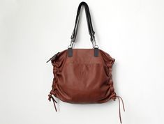 This smart 3-in-1 practical convertible leather bag can be easily carried as a tote on the shoulder, crossbody, & backpack. Crafted in rich premium soft Italian quality leather, featuring leather side cords that also change the shape of the bag to a smaller size with a rich leather gathering. The bag is designed with zipper closure, 2 adjustable & detachable shoulder straps, large open cell, suitable for laptops up to 17", 1 inner large zipper pocket + 2 large slip pockets, 2 external pockets (1 Versatile Leather Travel Bag With Leather Handles, Versatile Leather Tote Travel Bag, Versatile Leather Duffle Bag For Daily Use, Travel Hobo Bag With Leather Backing, Leather Hobo Bag With Leather Handles For Travel, Leather Crossbody Travel Bag For Everyday, Everyday Leather Crossbody Travel Bag, Leather Tote Duffle Bag For Everyday Use, Leather Tote Duffle Bag