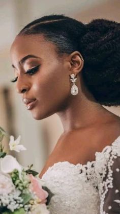 a woman in a wedding dress holding a bouquet