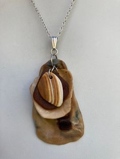 "Natural sea shell pendant necklace, ocean shells clustered with all different types of shells and a piece of brown beach glass on a Sterling plated 20\" loop chain. Unique seashell pendant measures 2 3/4\" X 1 1/2'' You can compare the size of the shells to the $0.50 cent piece in the pictures. All my necklaces are different and would be considered one of a kind. View my collection of Kingman Arizona Turquoise here: https://www.etsy.com/shop/MoonwaterJewelryShop?section_id=28192591  I've been selling on eBay since 2003 Came to Etsy to sell jewelry. Returns and exchange details ► RETURNS / EXCHANGES All items are handcrafted and custom pieces therefore we don't usually accept returns or exchanges on jewelry unless the fault was ours. Screens do not always reflect the same colors as well as Brown Pendant Jewelry For Beach, Brown Pendant Jewelry For The Beach, Unique Handmade Brown Shell Necklace, Brown Shell Necklace As A Gift, Bohemian Brown Shell Necklaces, Handmade Brown Shell-shaped Necklace, Handmade Brown Shell-shaped Jewelry, Unique Brown Shell Jewelry, Handmade Brown Shell Necklace