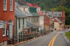 an empty street lined with houses in the mountains