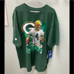 This Vintage Nfl Reebok T-Shirt Is Brand New Nfl Merchandise. It Features Brett Favre And The Authenticity Sticker Is On The Sleeve. There Is Also A Tag Attached Where Are You Can Send In Contact Information To The Nfl Shop. The Shirt Is 100% Cotton. Own A Piece Of History! #Vintage Green Crew Neck Top For Fans, Crew Neck Tops With Front Print For Fan Gear, Green Relaxed Fit Tops For Sports Season, Green Sports Season T-shirt For Fan Gear, Green Fan Merchandise T-shirt For Sports Season, Green T-shirt For Sports Season Fan Gear, Graphic Tee Sports Shirt In Green, Minnesota Vikings Football, Nfl Merchandise